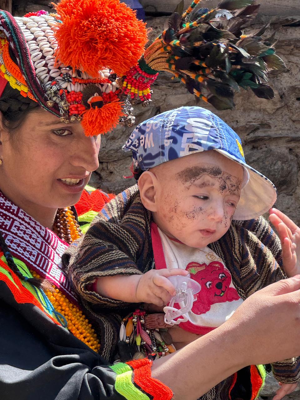 Kalasha people in traditional attire celebrating in the Kalash Valleys